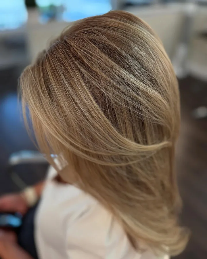 Soft honey blonde with swept layers